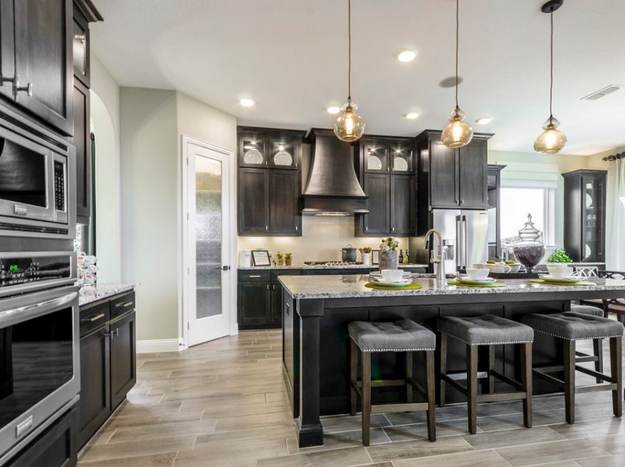 Landon Homes new home builder 432 Carrington Kitchen with large walk-in pantry and brown stained cabinets