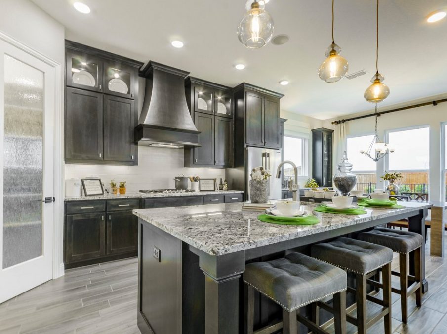 Landon Homes new home builder 432 Carrington Kitchen with brown stained cabinets and granite counter tops