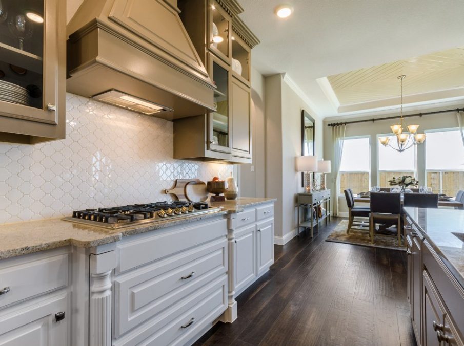Landon Homes new home builder 432 Carrington Kitchen brown stained cabinets and stainless steel fridge