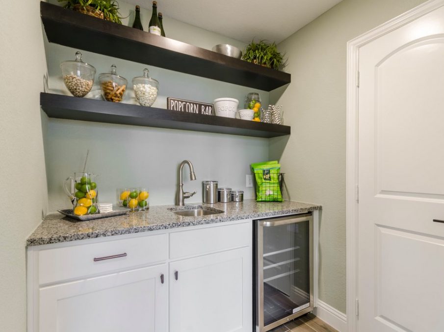 Landon Homes new home builder 432 Carrington Wet Bar with white painted cabinets and brown free standing shelves