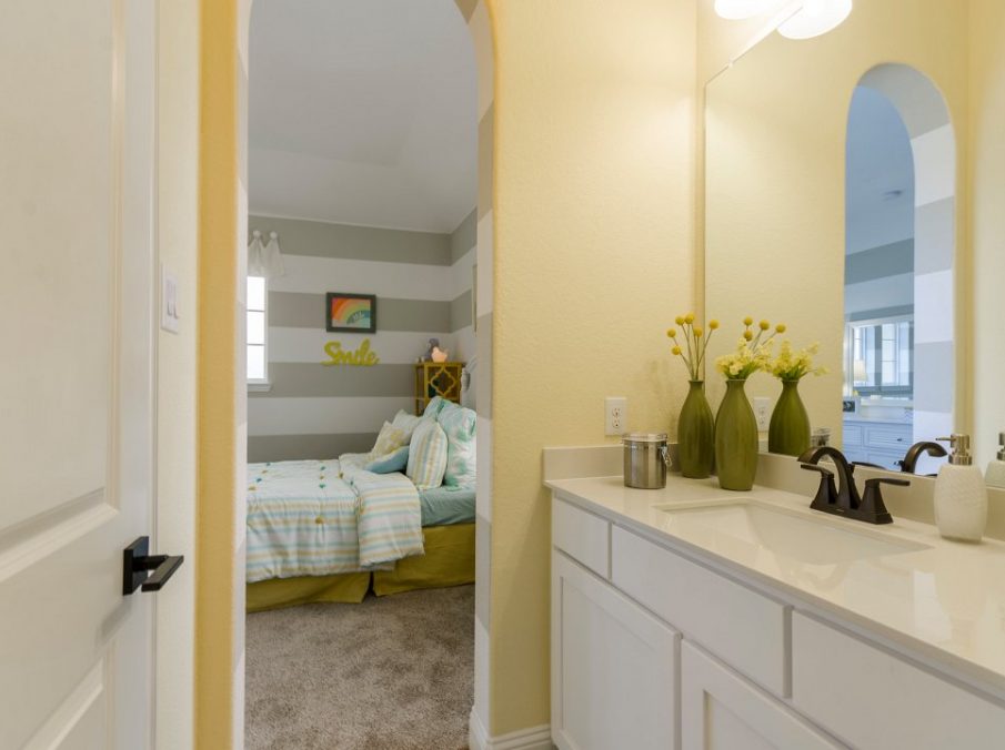 Landon Homes new home builder 432 Carrington Kids Bathroom with yellow walls and white painted cabinets