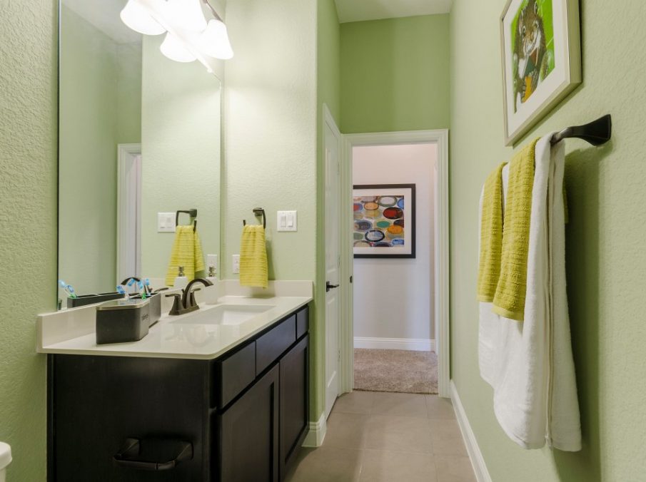 Landon Homes new home builder 432 Carrington Bathroom with green walls and brown stained cabinets